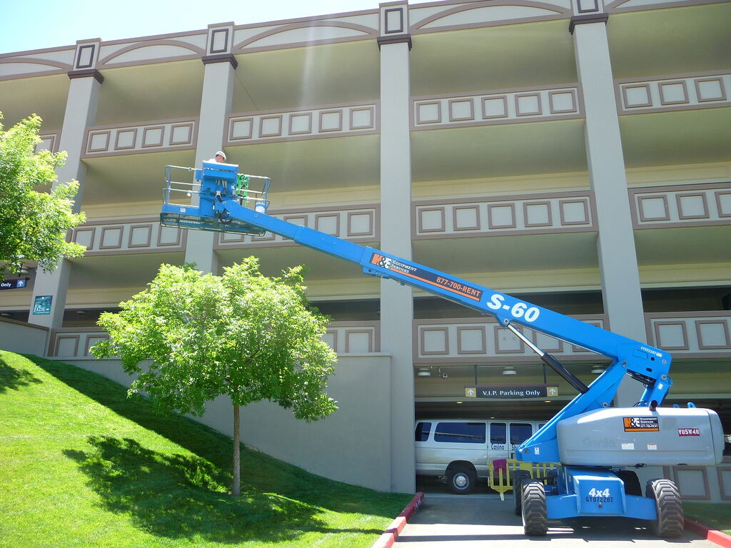 commercial painter on a basket lift
