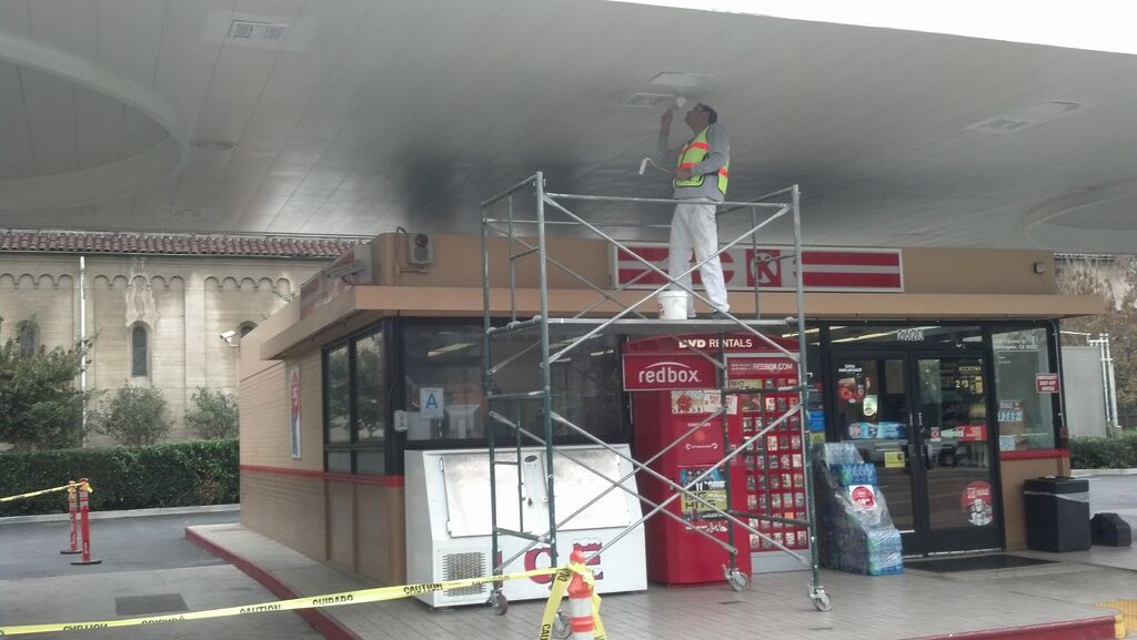 gas station painter on catwalk